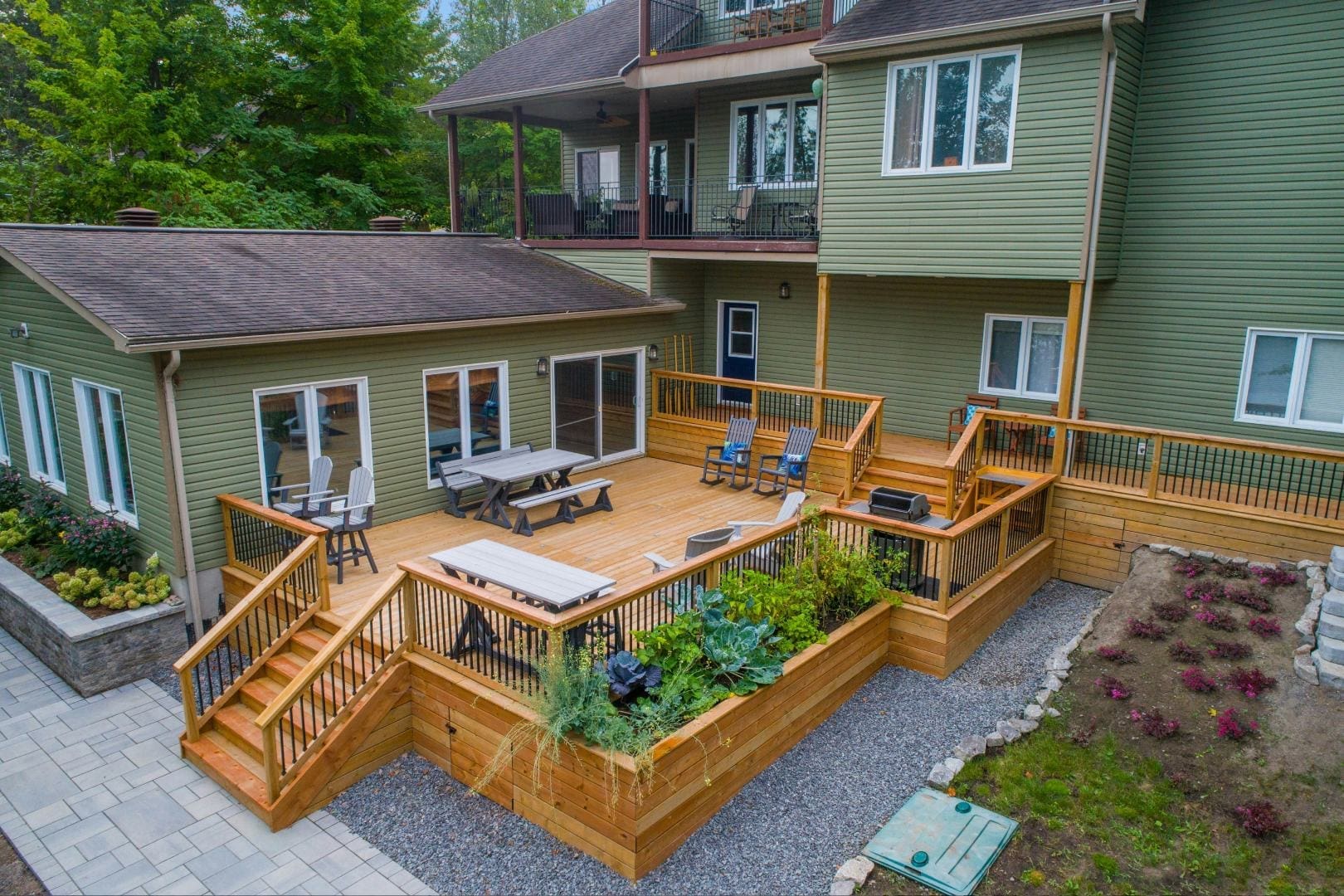 A large backyard with a deck and patio.