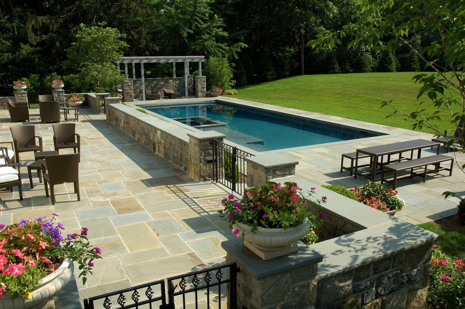 A pool with a bench and a gazebo in the middle of it.