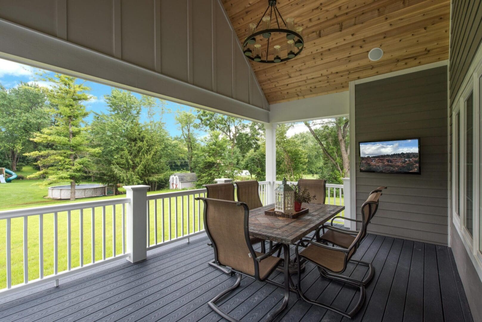 A table and chairs on the porch of a house.