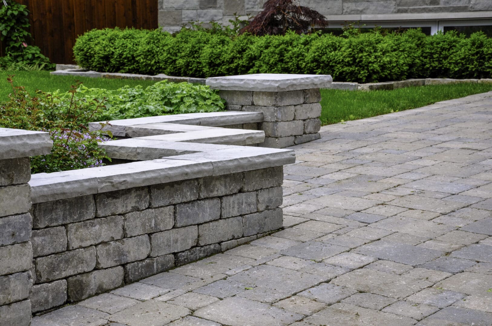 A stone wall with steps leading to the ground.