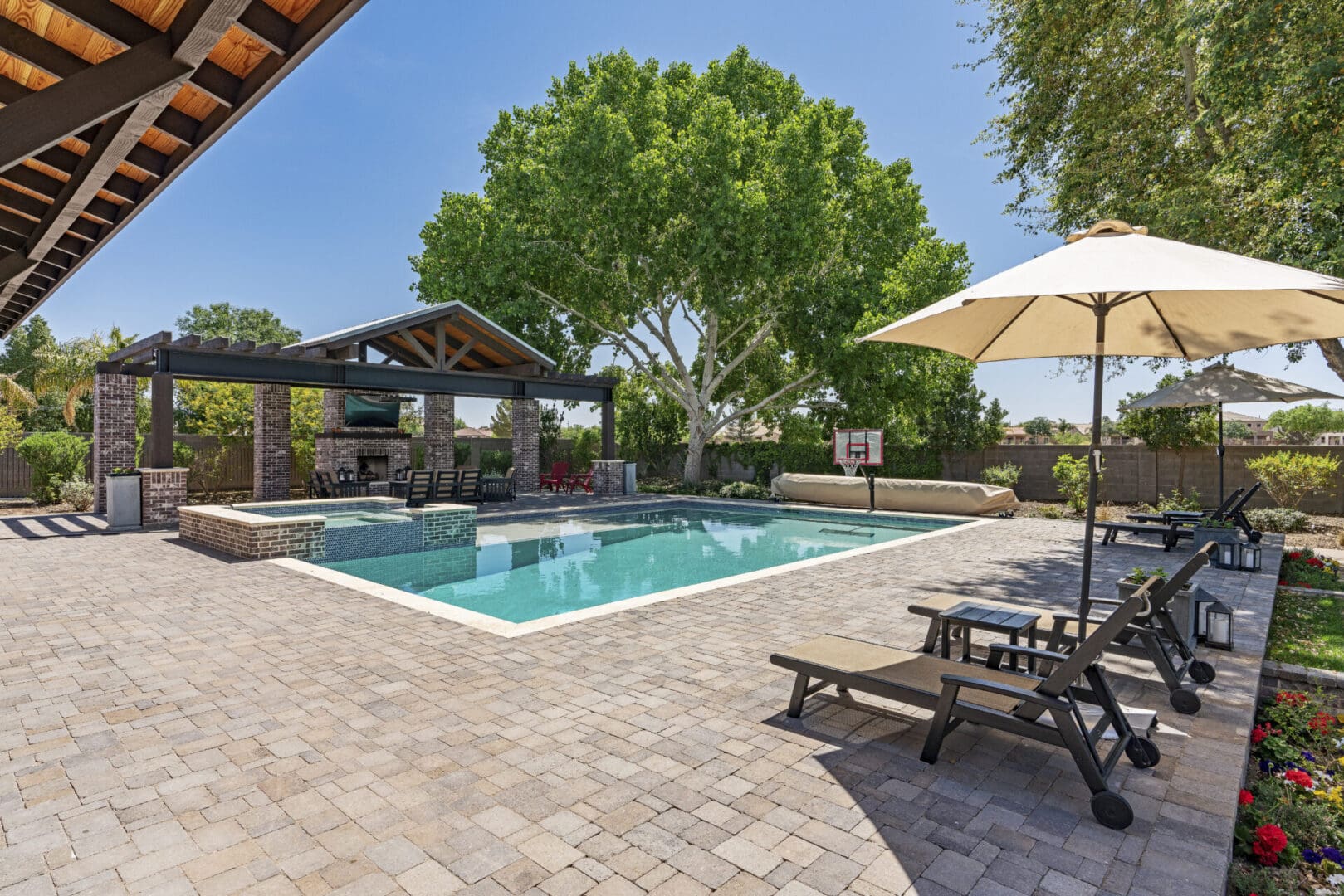 A pool with an umbrella and some chairs