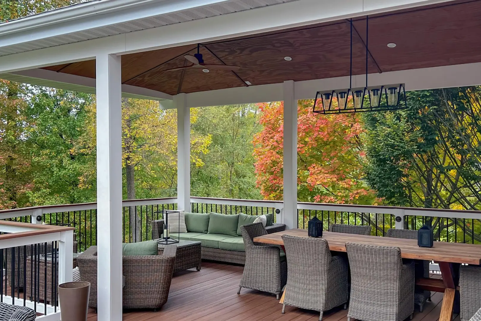 A porch with furniture and tables on it.